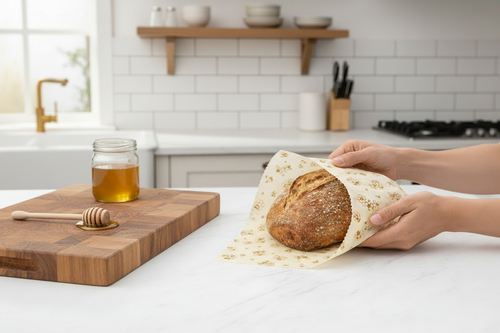 Loaf of bread wrapped in beeswax wrap on a white surface